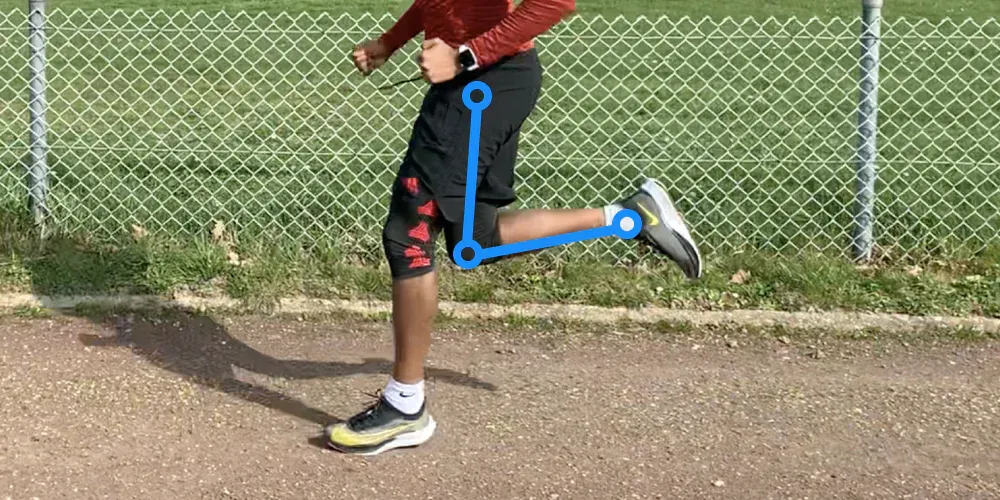 Runner's back leg folded high under the buttock, with markers on the hip, knee and foot